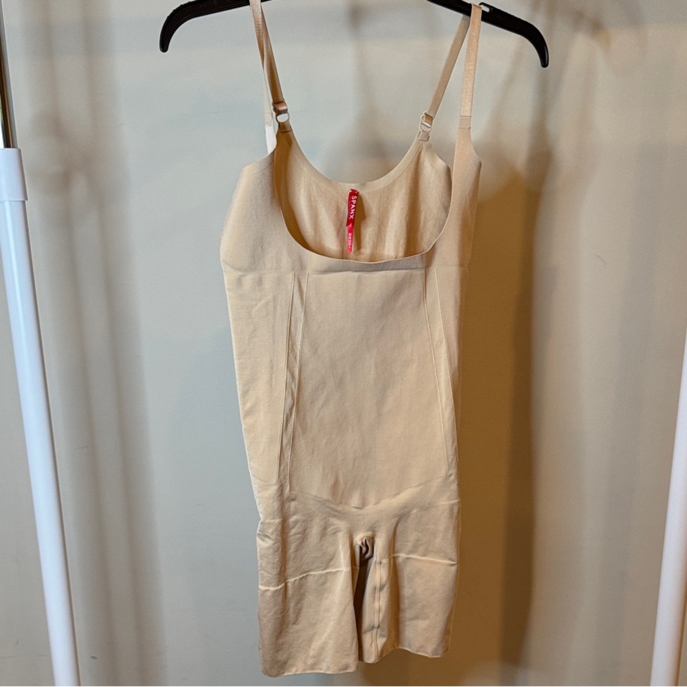 SPANX OnCore Open-Bust Mid-Thigh Bodysuit in nude.
